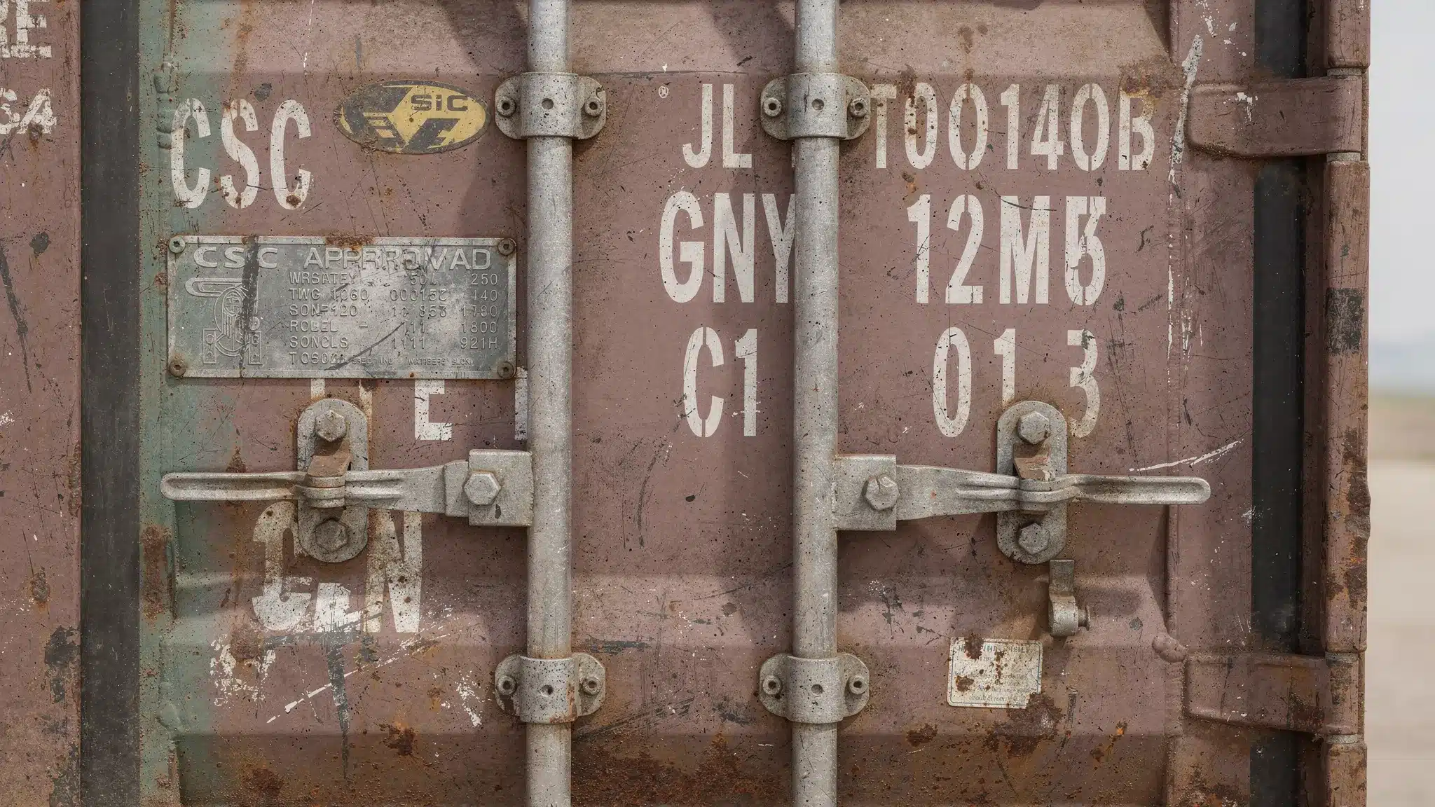 Seaworthy Containers for Sale: What “Cargo-Worthy” Means 1 Close-up of a shipping container door showing the CSC safety approval plate, container ID markings, locking bars, and door gasket area for inspection.